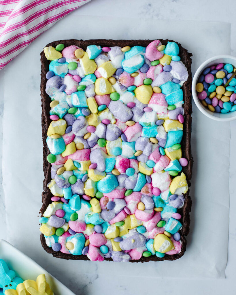 colorful marshmallow pieces melted on top of chocolate cake.