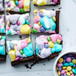 sliced cake bars themed for Easter on a piece of parchment paper.