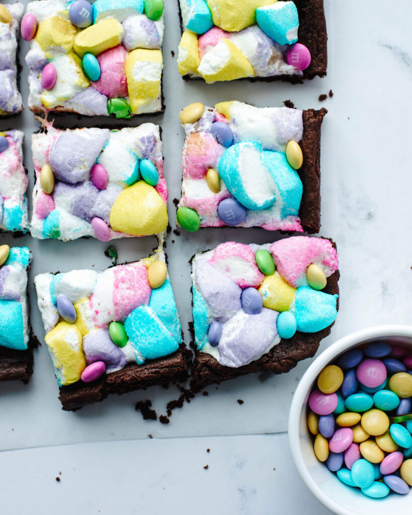 sliced cake bars themed for Easter on a piece of parchment paper.