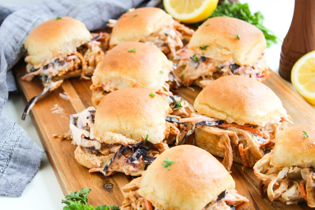 shredded chicken coated in sauce and a homemade slaw to make sliders.