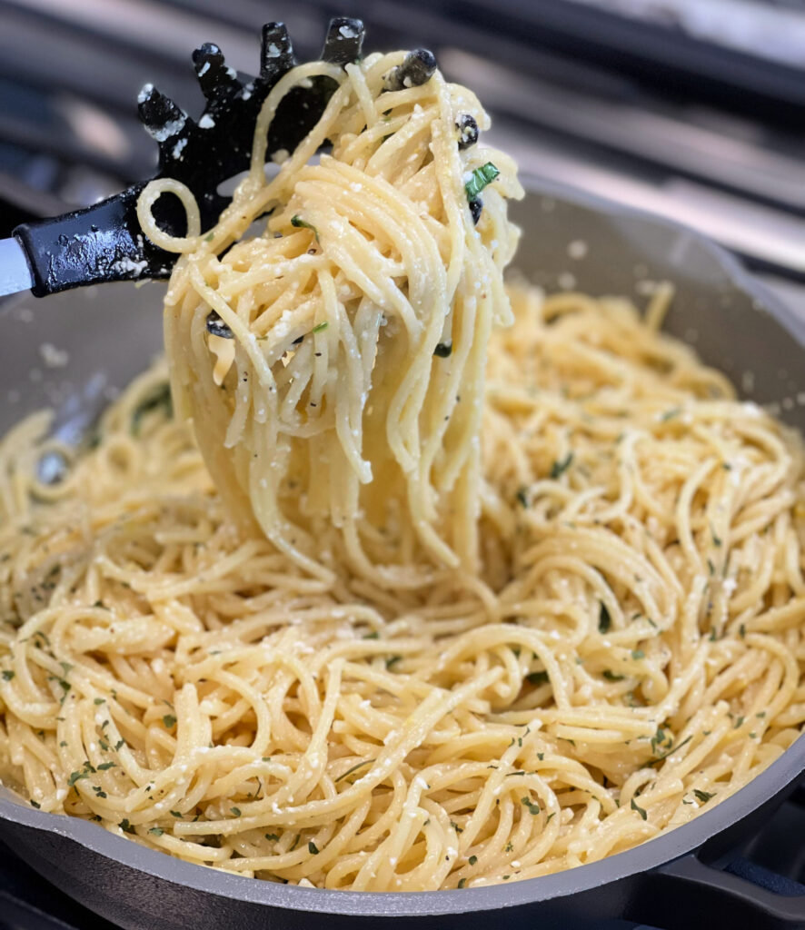 lemon, basil, and parmesan combined into a sauce over spaghetti noodles