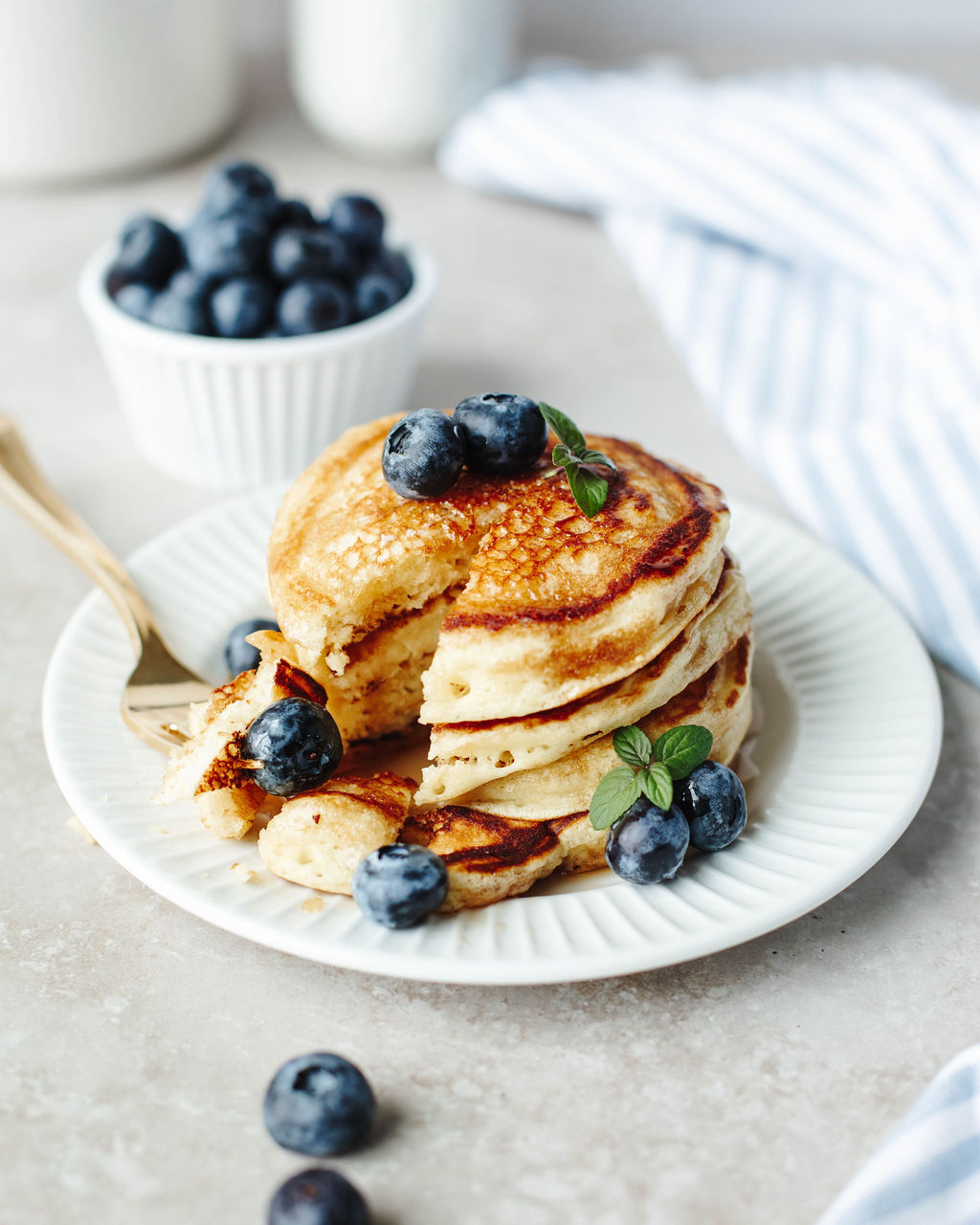 a stack of pancakes with blueberries on top.