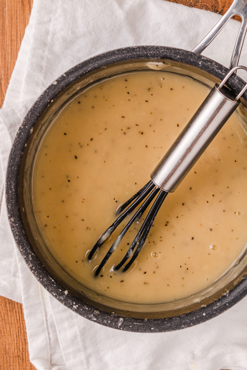 chicken gravy in a black pot ready to serve.