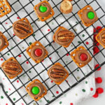 rolo pretzel treats lined on a wire rack.