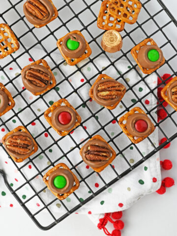 rolo pretzel treats lined on a wire rack.