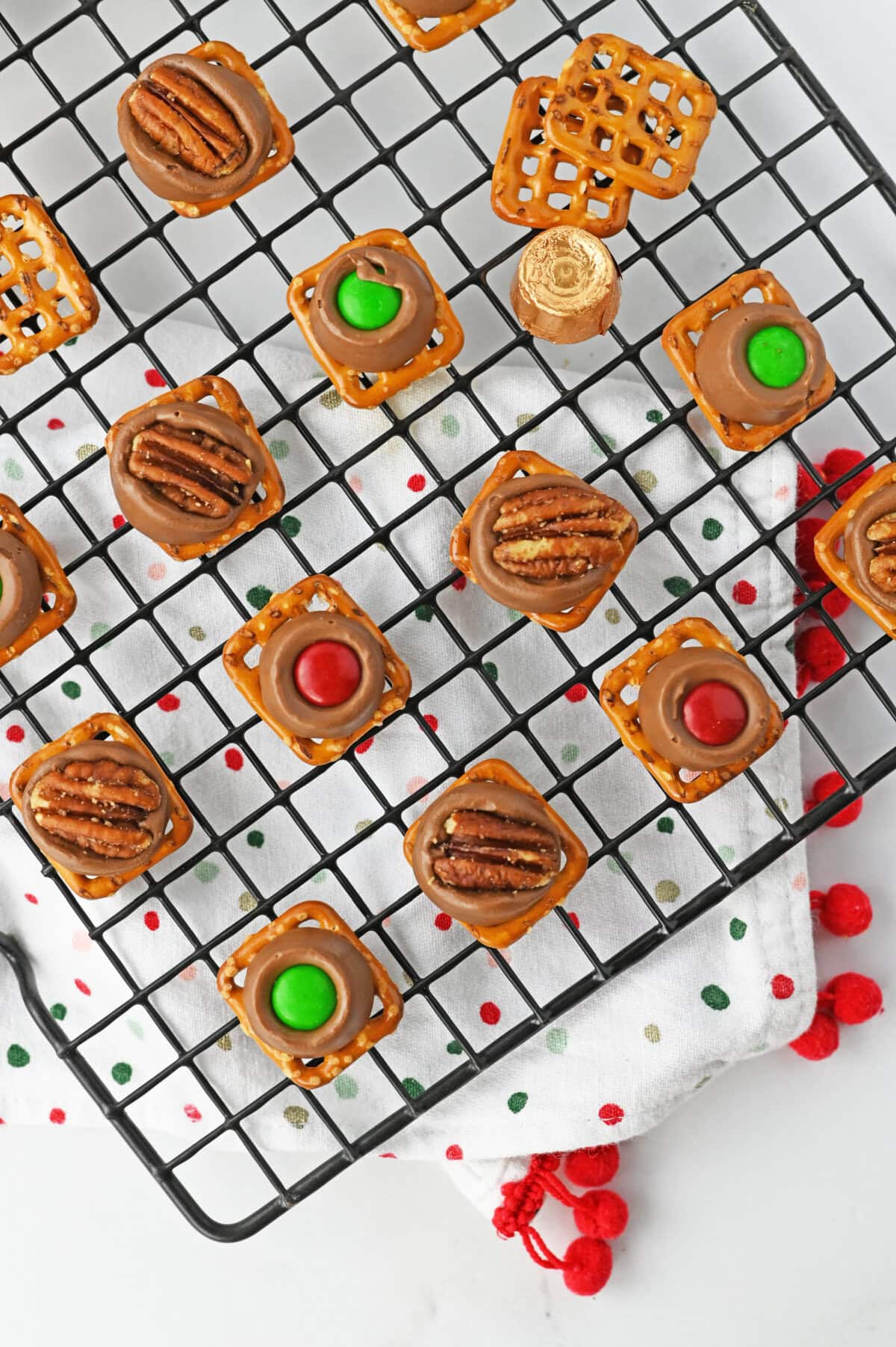 rolo pretzel bites on a black wire cooling rack.