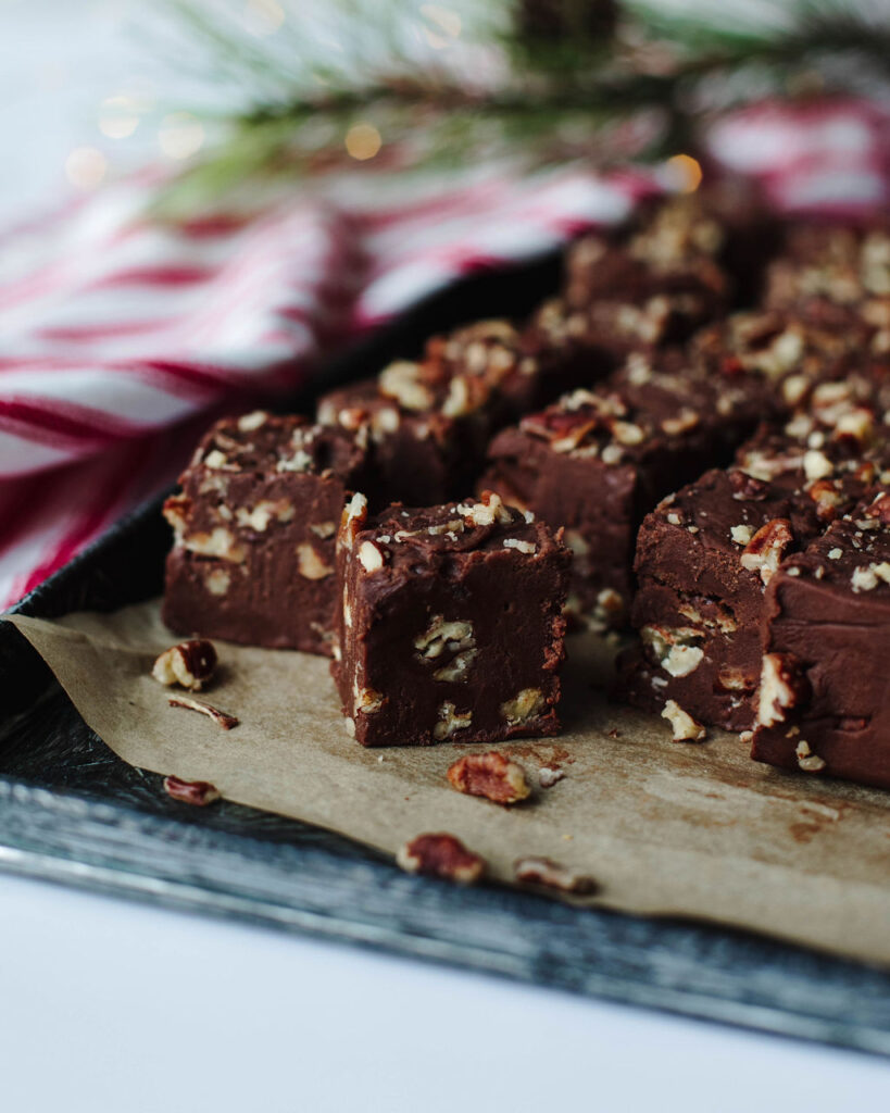 fantasy fudge cut into small pieces and placed on a wood board.