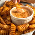 fries dipped into a creamy, tangy dip