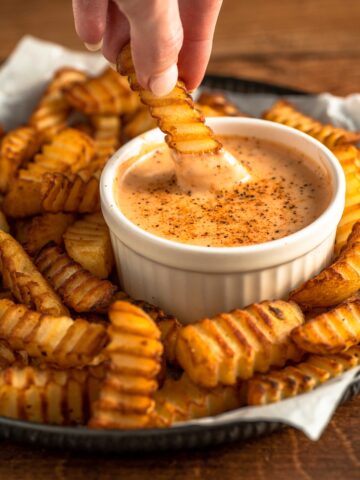 fries dipped into a creamy, tangy dip