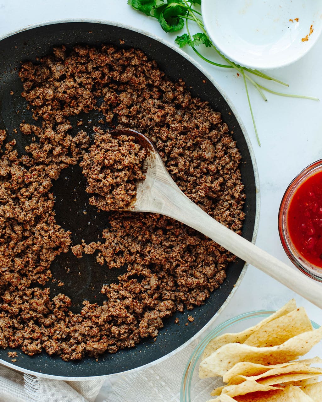 cooked ground beef seasoned with taco seasoning in a skillet.