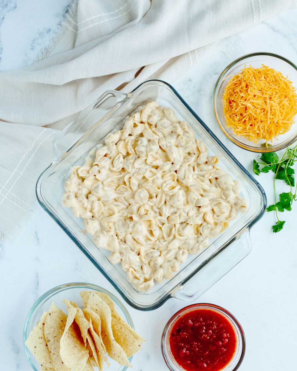 sour cream coated pasta spread into a prepared 8x8 baking dish.