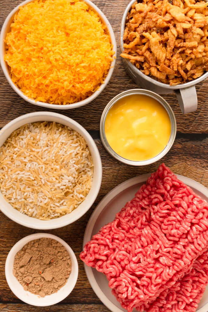 all the ingredients needed to make cheesy beef and rice casserole.