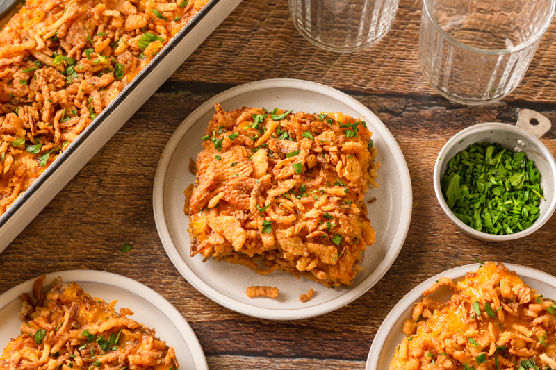 a fried onion topped dinner with meat and rice.