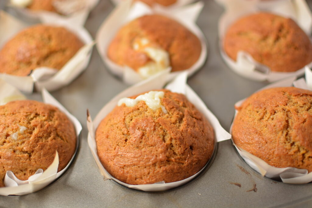 perfectly spiced carrot cake muffins with a sweet filling