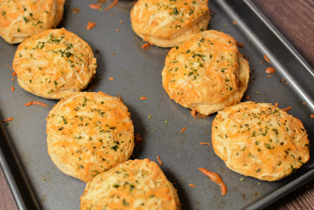 fluffy, tender biscuits with a garlic butter sauce on top and melted cheese