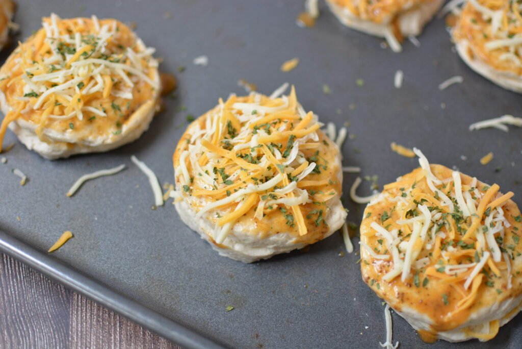 shredded cheese over biscuits