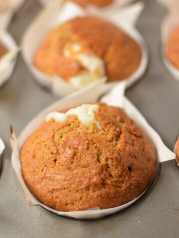 perfectly spiced carrot cake muffins with a sweet filling