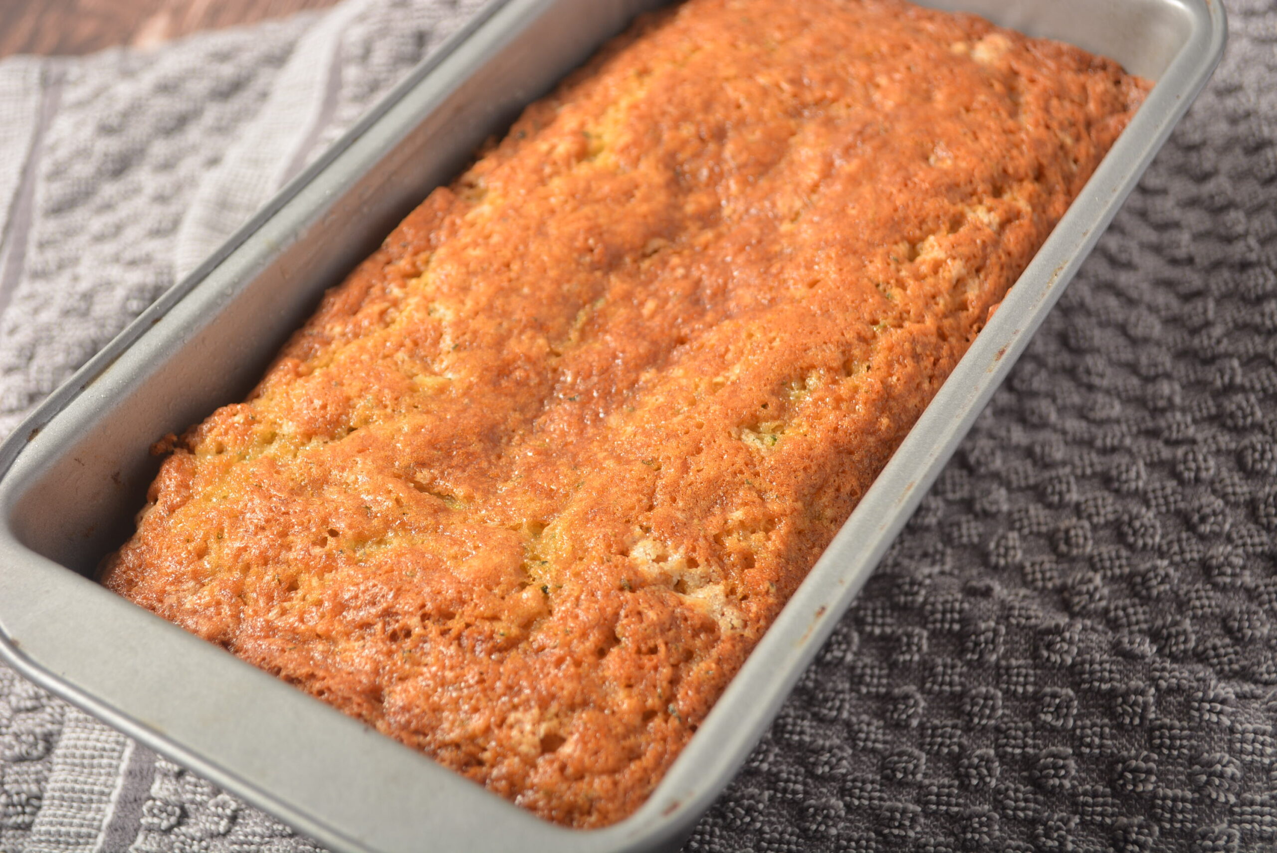 a loaf of banana squash bread in a loaf pan.