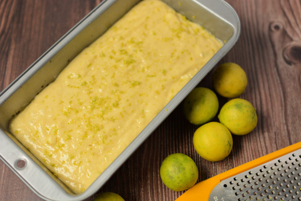 key lime quick bread batter poured into a loaf pan