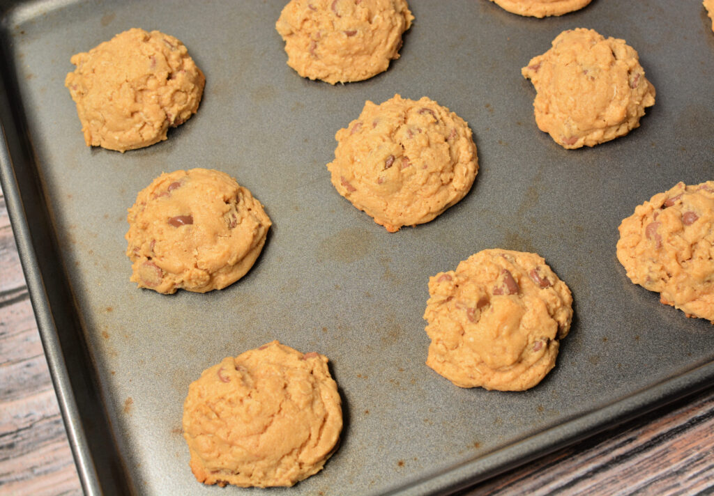 baked peanut butter oatmeal chocolate chip cookies on a cookie sheet