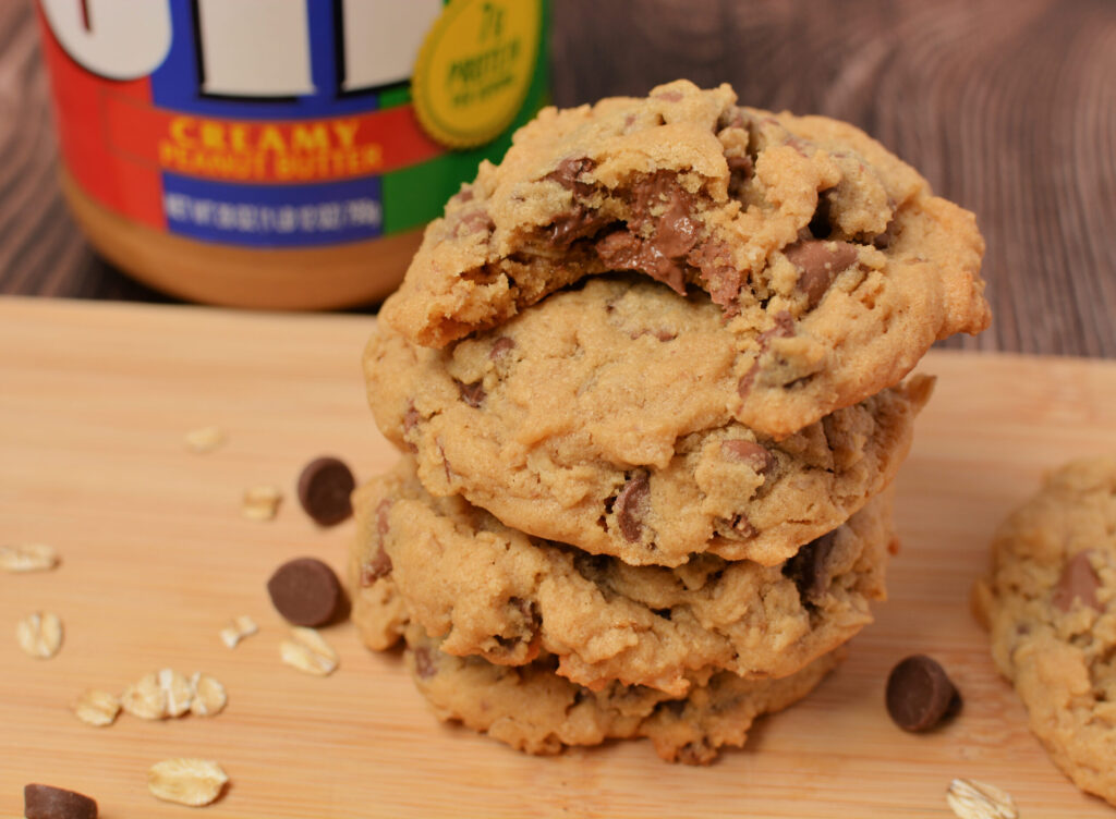 a stack of cookies next to a jif jar of peanut butter