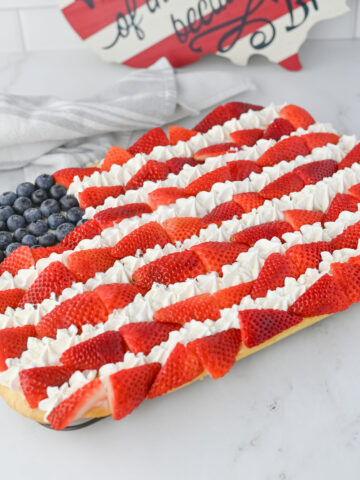 a Patriotic dessert pizza with fresh fruit in the shape of a flag.