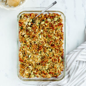a baked one pan meal with fresh summer vegetables, shredded meat, and stuffing.