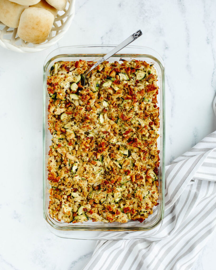a baked one pan meal with fresh summer vegetables, shredded meat, and stuffing.