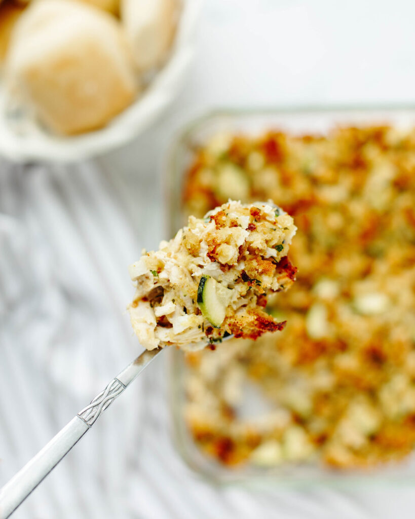 a spoon scooping up  a bite of a one pan meal with stuffing.
