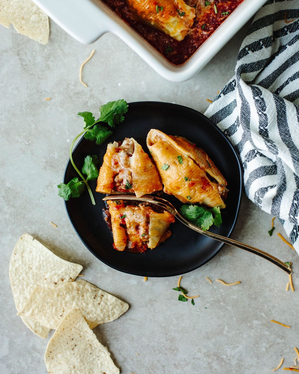 Taco stuffed shells topped with cilantro for an easy Mexican dinner.