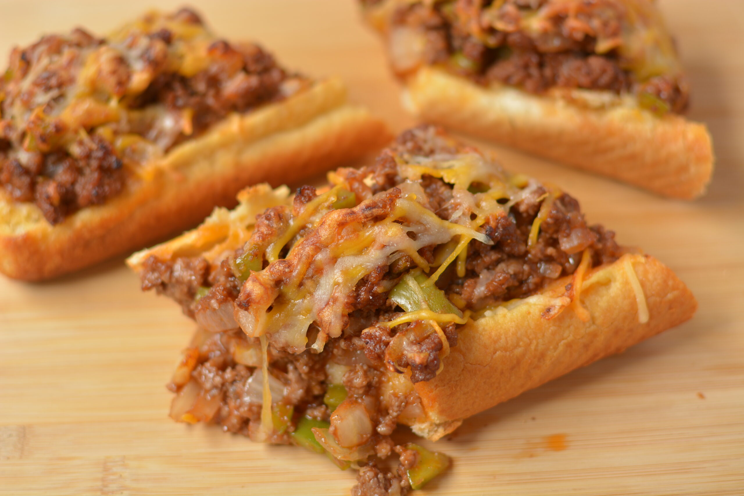 garlic bread sloppy joes cut on a wood board.