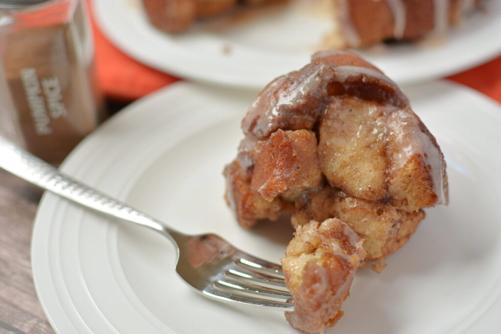 a piece of monkey bread with pumpkin pie spice added and served on a plate.
