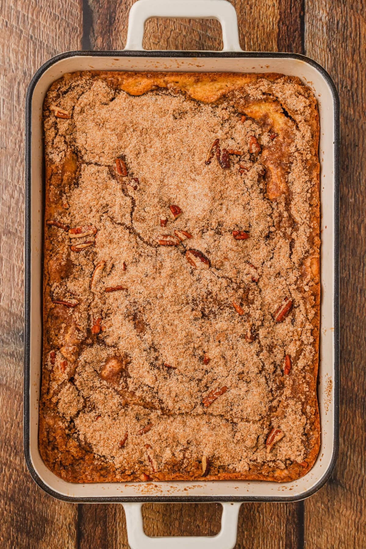 baked applesauce coffee cake in a white baking dish.