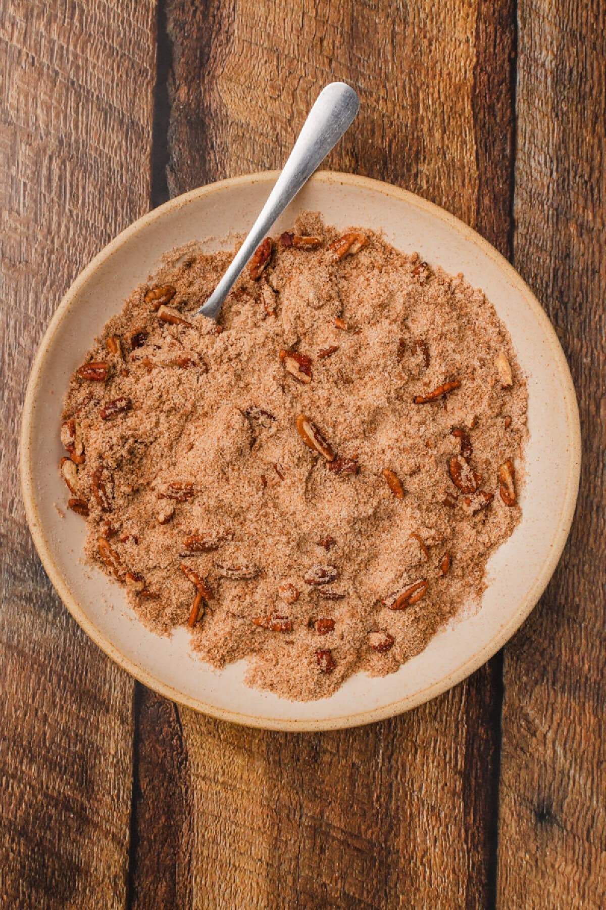 a cinnamon streusel mixture combined with a fork on a plate.