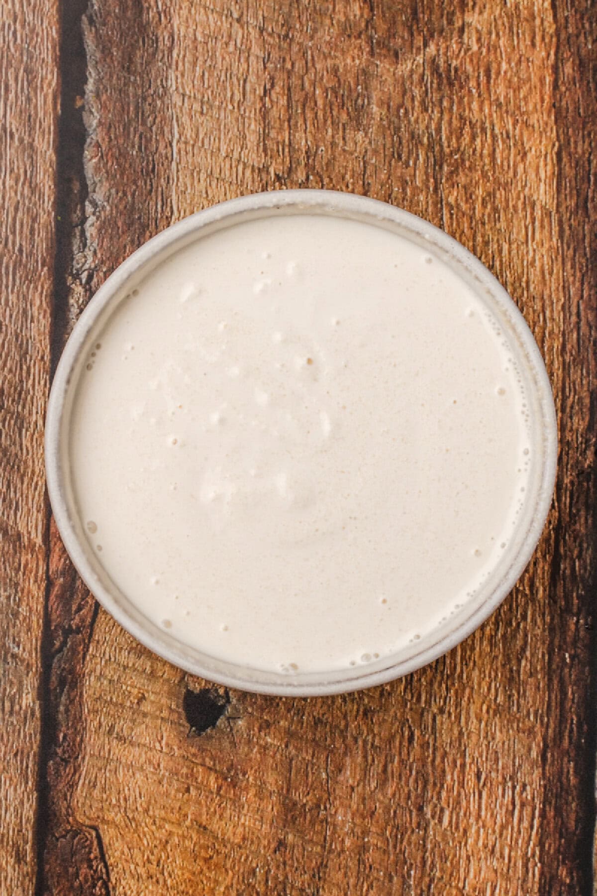 applesauce, sour cream, and vanilla extract combined in a small bowl.