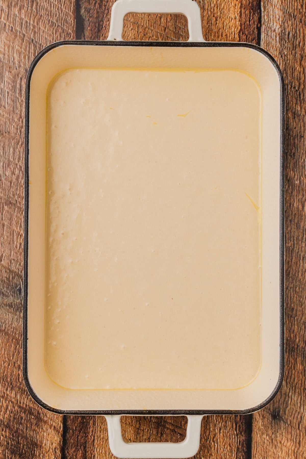 cake batter poured into a prepared 9x13 baking dish.