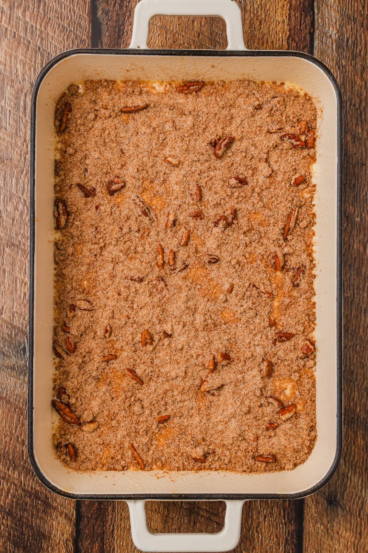 streusel mixture spread on top of cake batter in a pan.