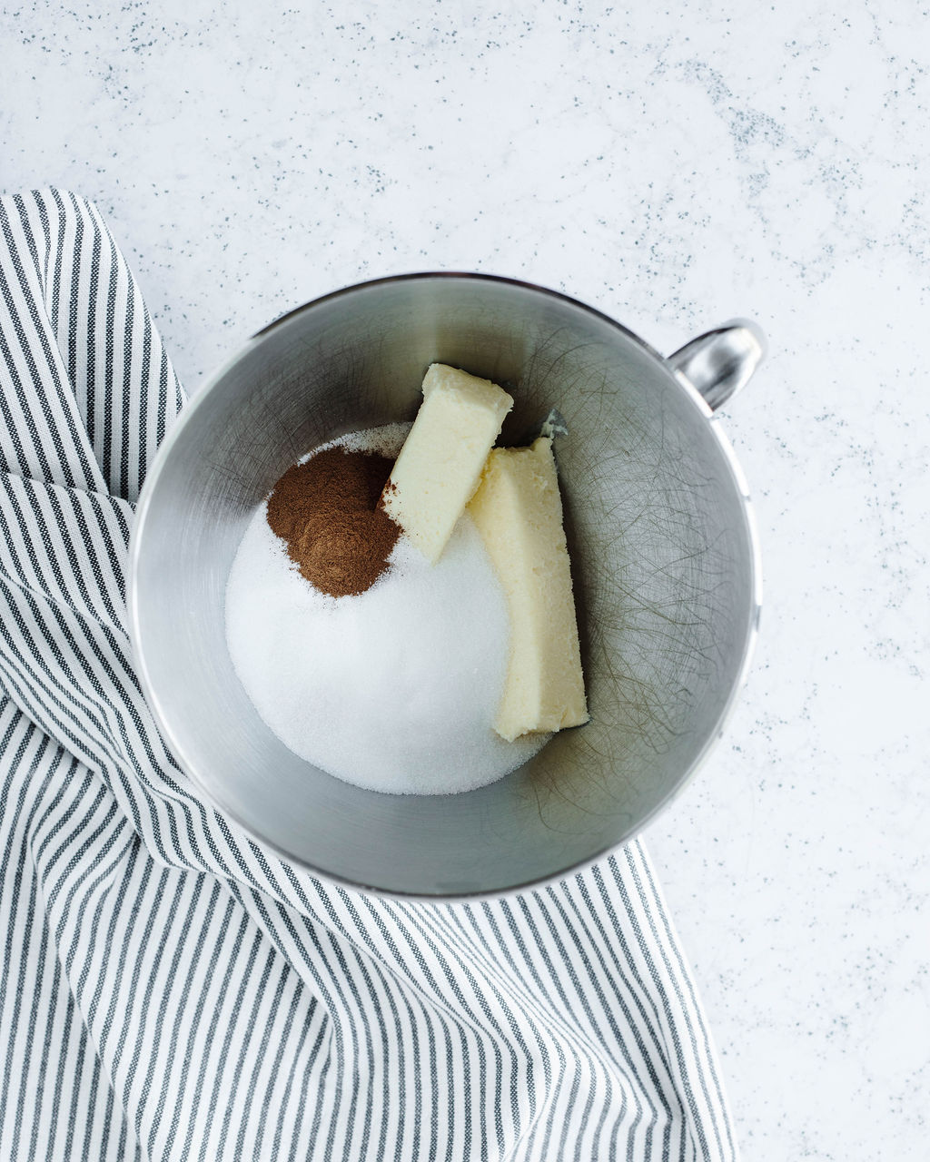 butter, sugar, and cinnamon creamed together in a mixing bowl.