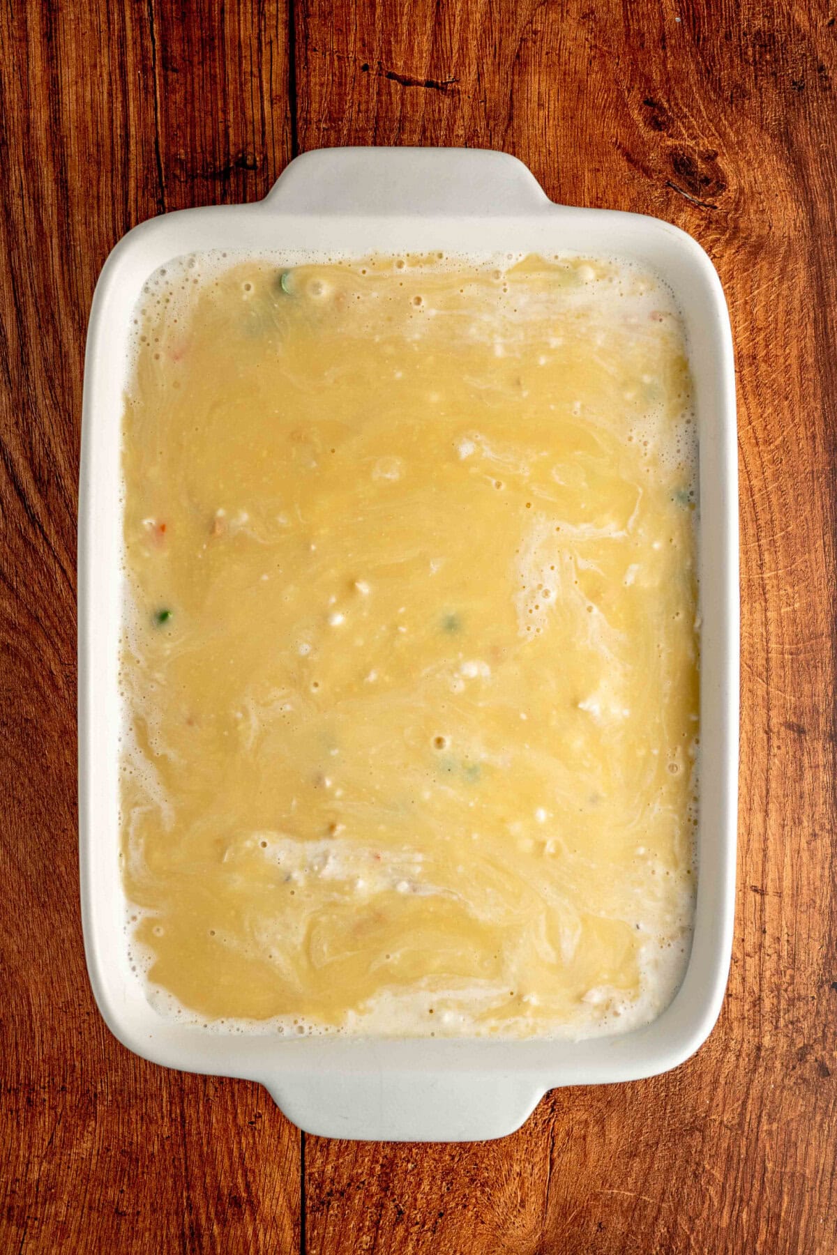 cream of chicken soup mixture poured on top of veggies and chicken.