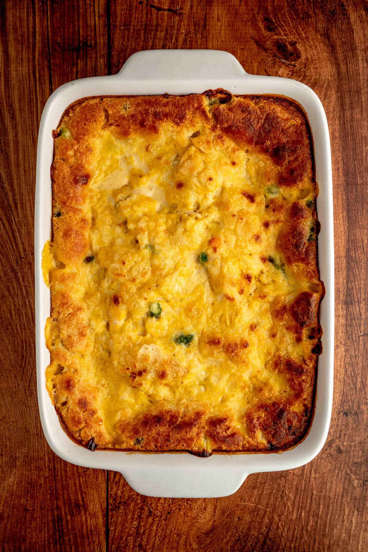 baked chicken cobbler in a white casserole dish.