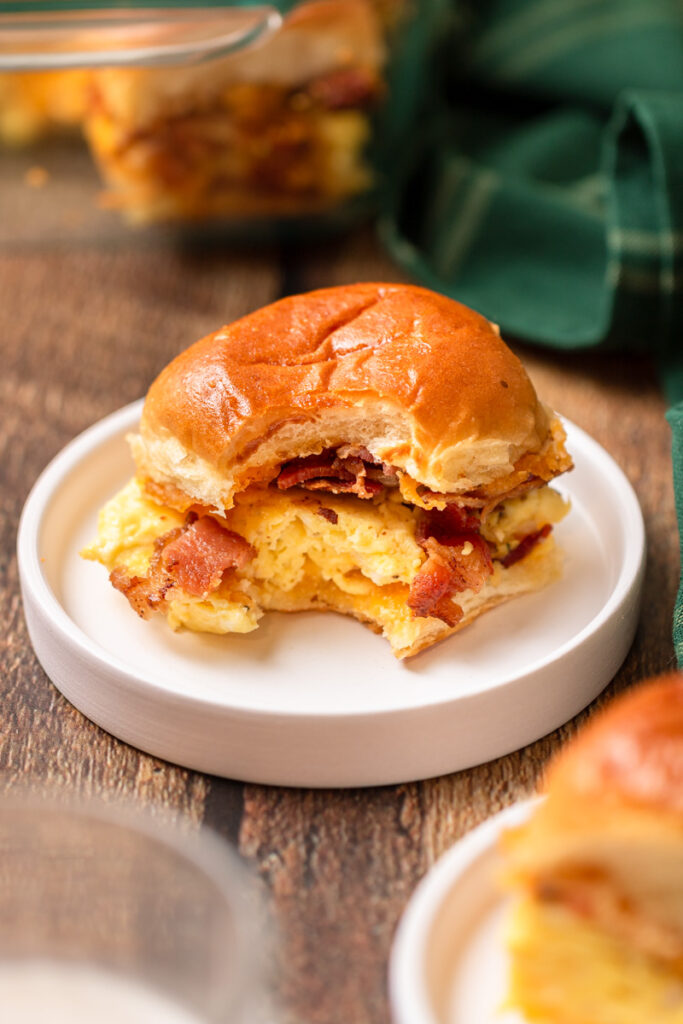 Fluffy rolls with scrambled eggs, cheese, and bacon inside and a butter Maple topping.