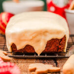 cream cheese frosting coating gingerbread loaf.