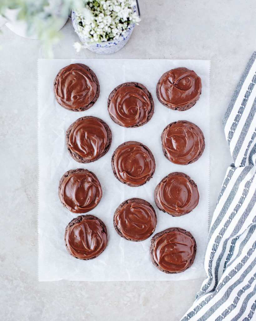 frosted topped cake mix cookies on a white surface.