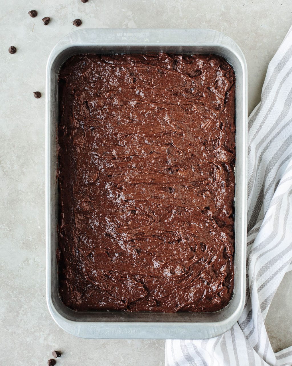 Easy chocolate peanut butter dump cake batter spread evenly in a baking pan before baking.