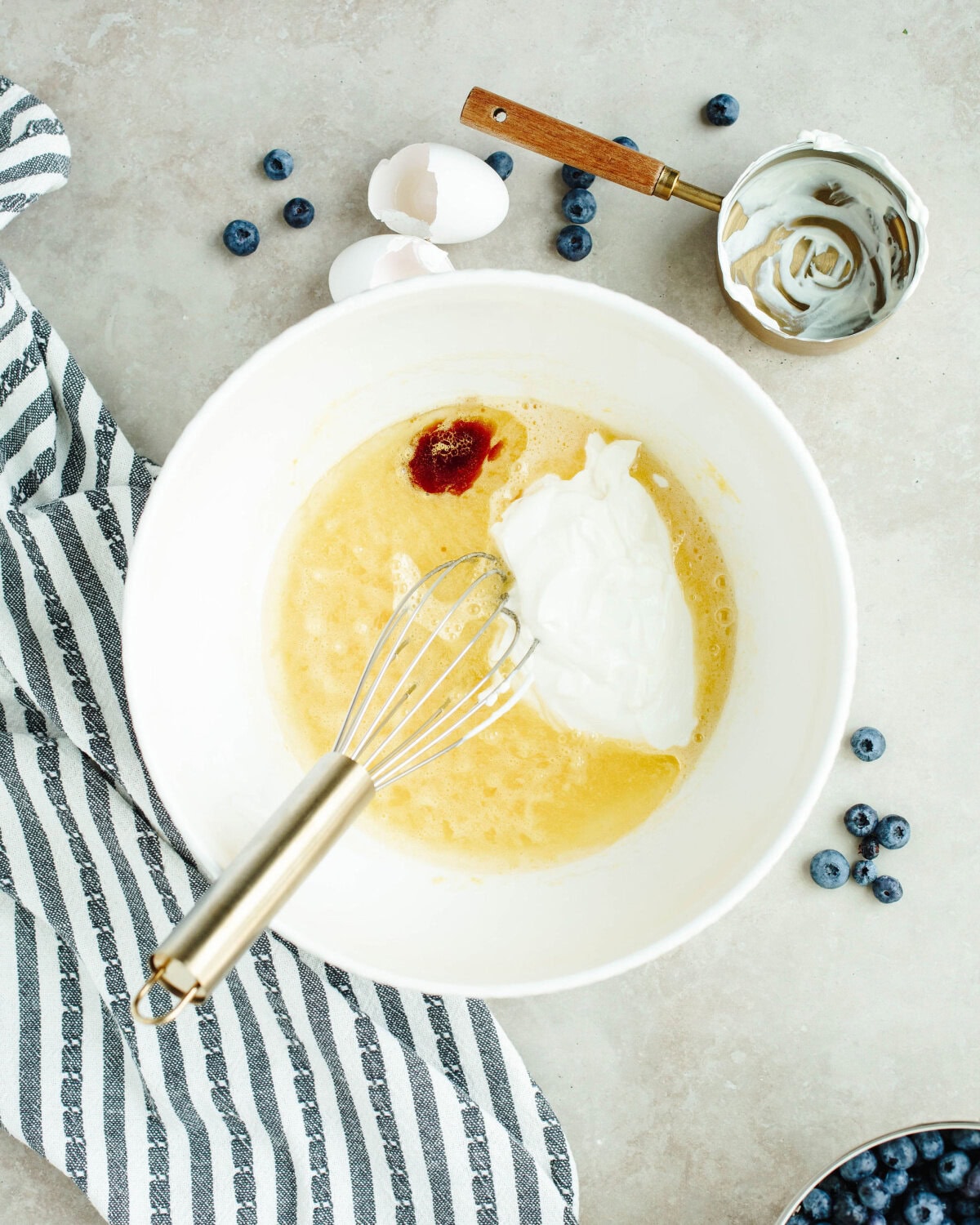 sour cream, oil, and vanilla added to a mixing bowl.