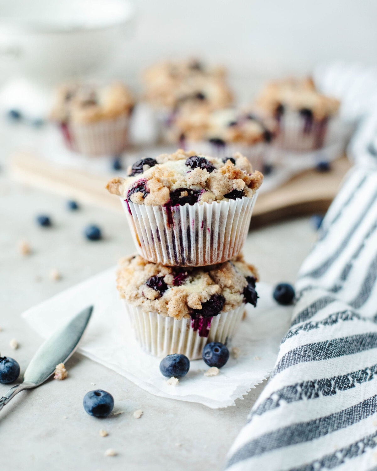 stacked blueberry crumb muffins baked and ready to serve.