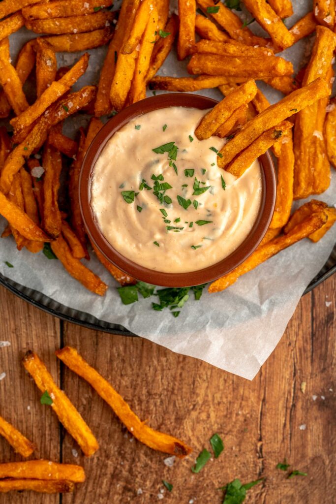 a spicy and sweet sauce with crispy fries dipped in.