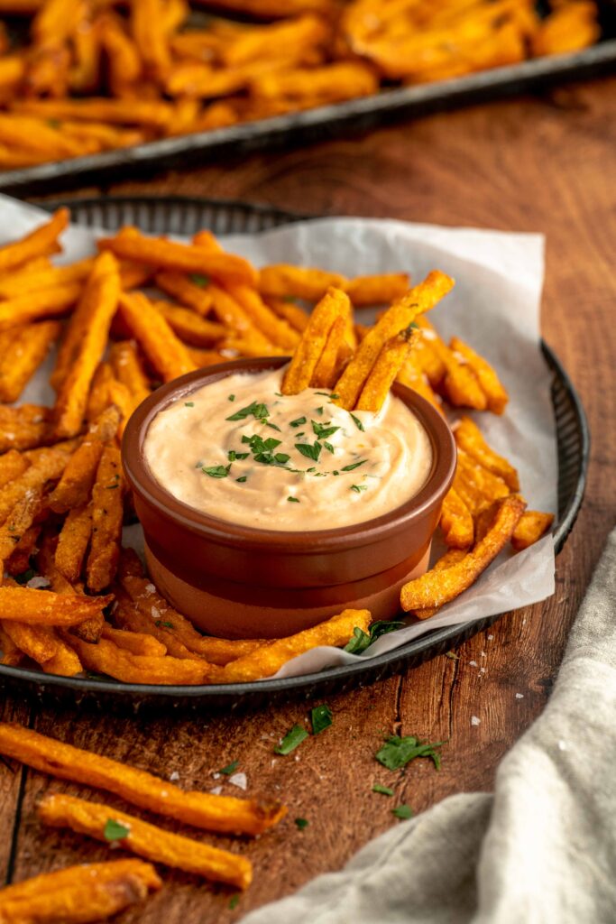 sweet potato fries dipped into a tangy sauce.