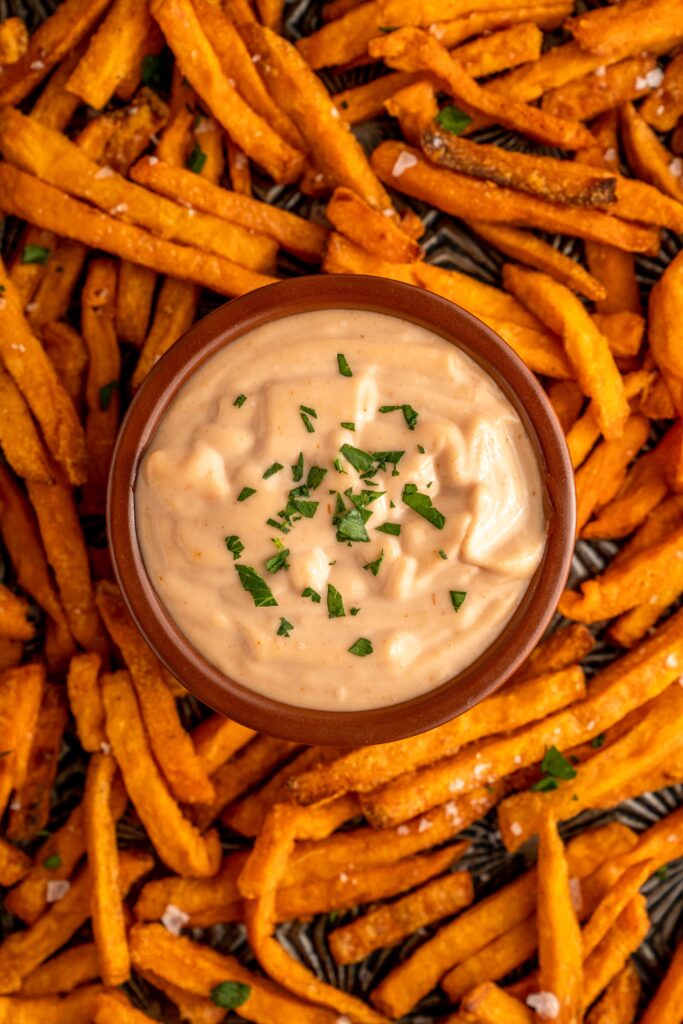 creamy mayonnaise based sauce in a bowl with fries.