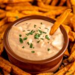 a sweet and spicy mayonnaise sauce with fries.